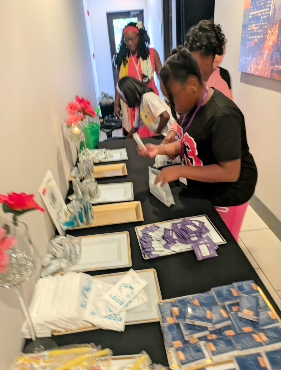 Girls assembling a thousand hygiene kits through Melanated Inc. at the Girl Yes You Can Conference