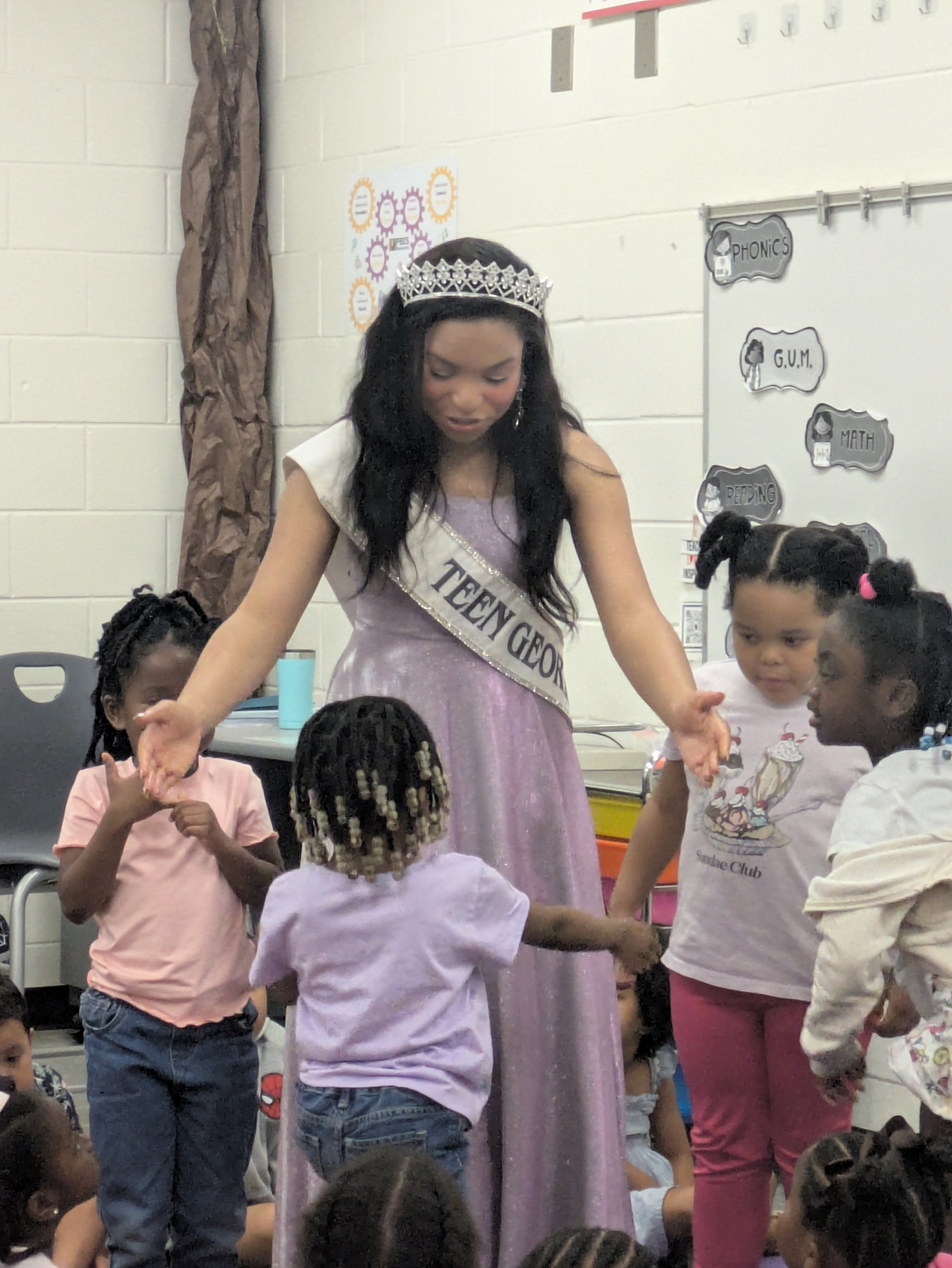 Victoria Mylan reading and connecting with young children during a school visit