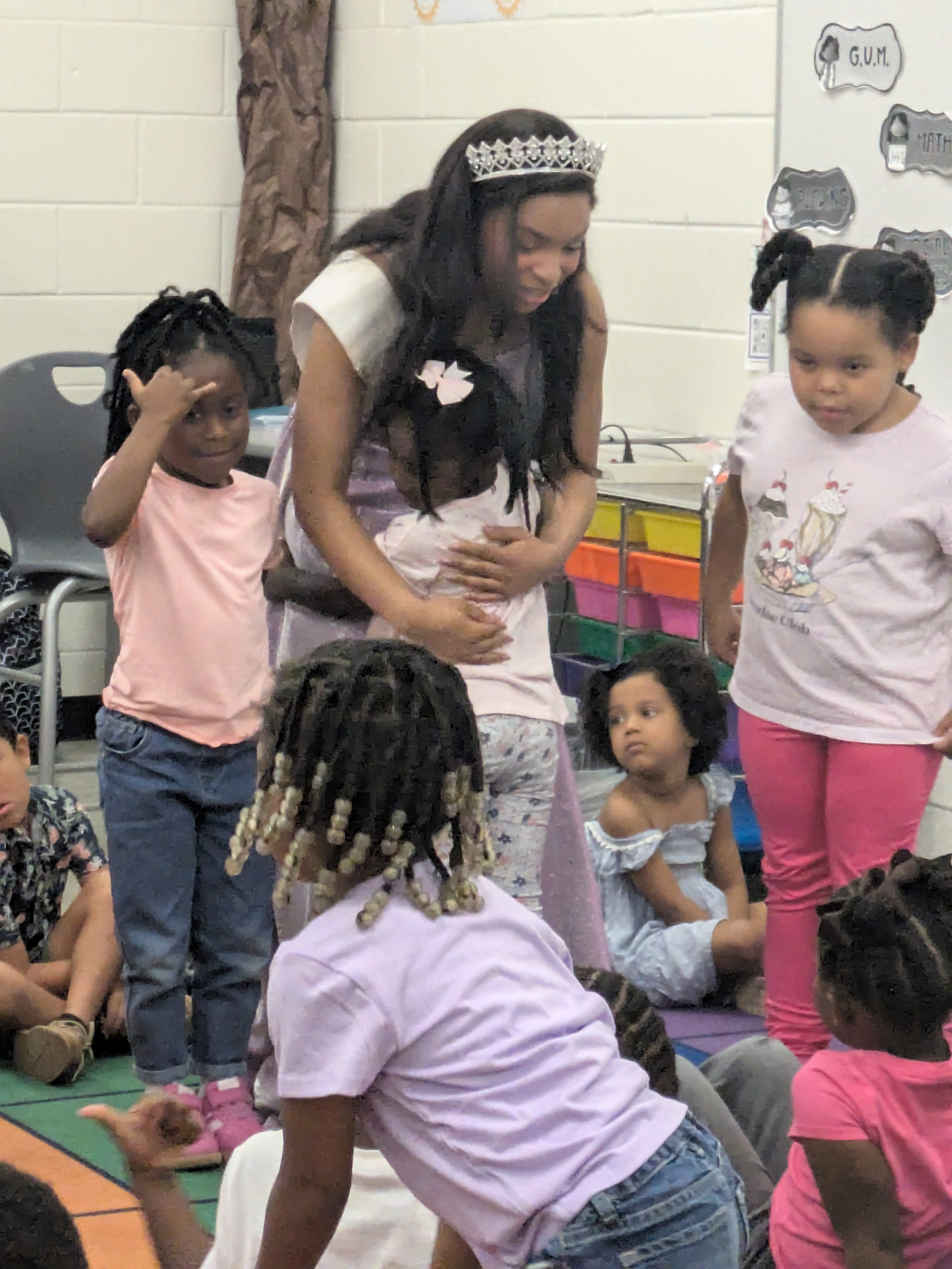 Victoria Mylan hugging a young child during a classroom visit