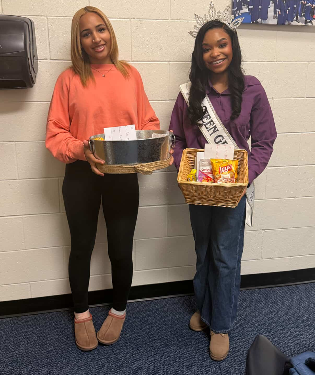 Victoria Mylan and a volunteer with snack baskets for a Girl Yes You Can community service drive