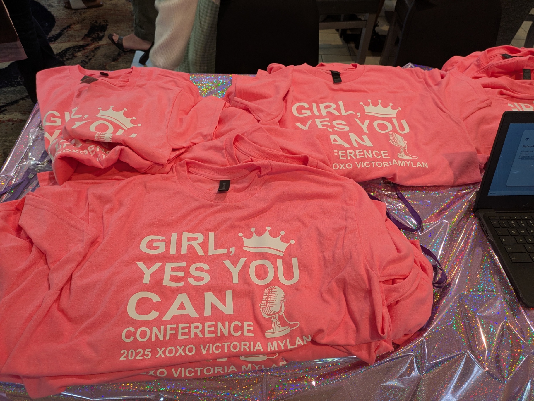 Girl Yes You Can Conference 2025 t-shirts on display