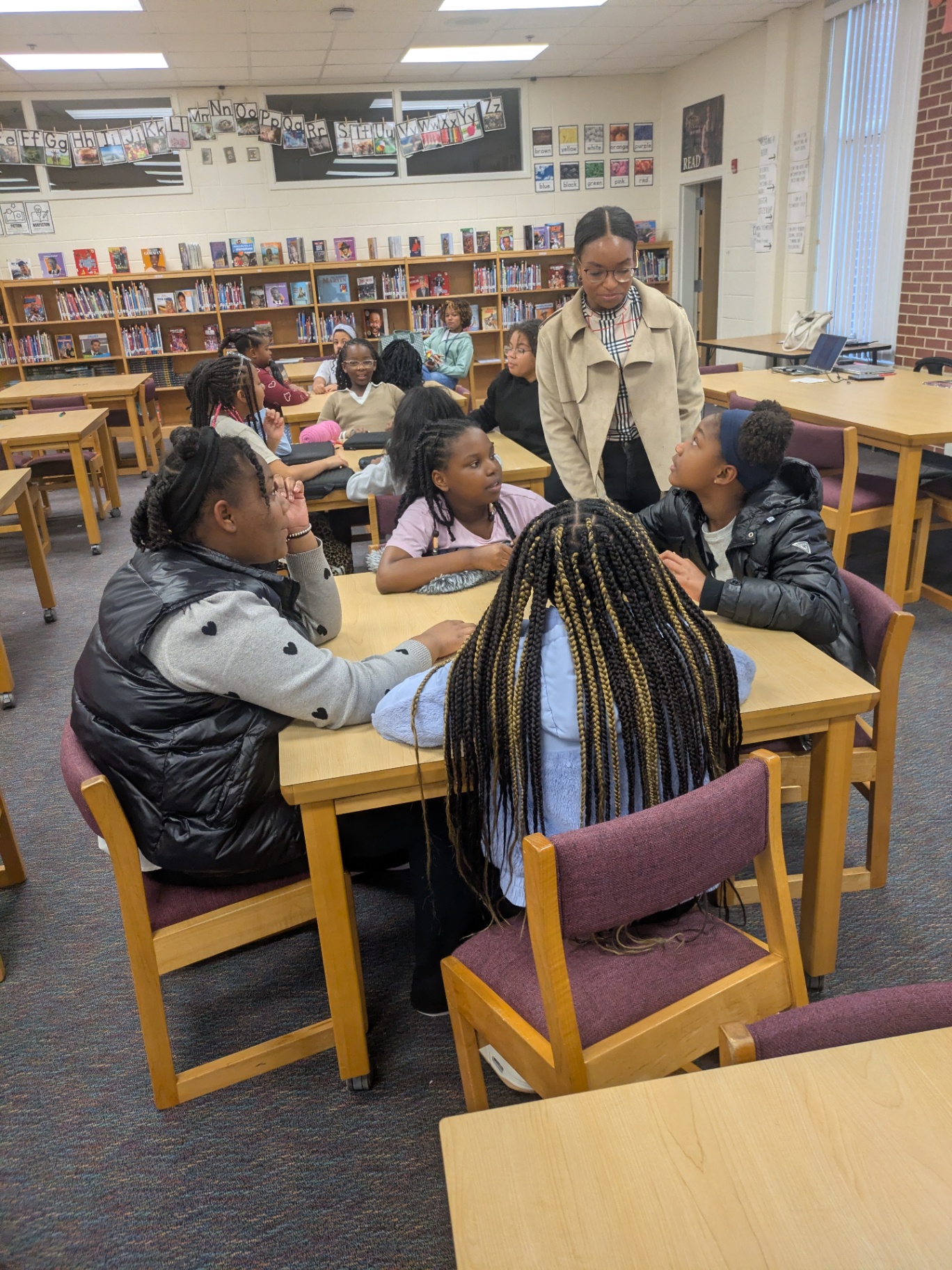 Victoria Mylan mentoring students in a school library